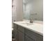 The bathroom features a gray vanity with a white countertop and a large mirror at 977 Lewis Rd, Zebulon, NC 27597