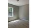 A bedroom with light grey paint, a window, and white trim is under construction at 977 Lewis Rd, Zebulon, NC 27597