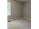 A bedroom with light grey paint, a window, and white trim is under construction at 977 Lewis Rd, Zebulon, NC 27597