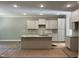 New kitchen with recessed lighting, an island with granite countertops, and white cabinets at 977 Lewis Rd, Zebulon, NC 27597