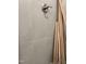 Shower featuring gray tiling, a brushed chrome shower head, and wooden trim at 977 Lewis Rd, Zebulon, NC 27597
