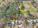 Neighborhood aerial view of the home near a horse pasture, highlighting the tree coverage at 102 Stagville Ct, Cary, NC 27519