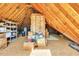 Large unfinished attic with wood rafters, insulation, storage boxes, and utilities at 102 Stagville Ct, Cary, NC 27519