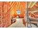 Spacious attic with exposed rafters, insulation, skylight, and shelving units for storage at 102 Stagville Ct, Cary, NC 27519