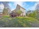 Spacious backyard with lawn and deck attached to a traditional home at 102 Stagville Ct, Cary, NC 27519