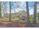 Large backyard with a deck, lawn, and patio, framed by mature trees at 102 Stagville Ct, Cary, NC 27519