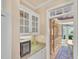 Home dry bar area features glass front cabinets, granite countertops, and wine fridge at 102 Stagville Ct, Cary, NC 27519