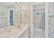 Bright bathroom featuring a bath tub with a shower with patterned wallpaper at 102 Stagville Ct, Cary, NC 27519