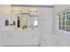 Light-filled bathroom boasts double sinks, a bathtub with jets, and a separate shower at 102 Stagville Ct, Cary, NC 27519