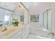Light-filled bathroom boasts double sinks, a bathtub with jets, and a separate shower at 102 Stagville Ct, Cary, NC 27519