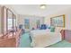 Bright bedroom with two windows, painted art, traditional furnishings, and a plush armchair at 102 Stagville Ct, Cary, NC 27519