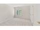 Neutral colored bedroom with a window and a door at 102 Stagville Ct, Cary, NC 27519
