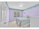 Bedroom with lilac walls, window, and plush carpeting at 102 Stagville Ct, Cary, NC 27519