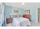 Cozy bedroom featuring a comfortable bed with blue walls and a wooden dresser at 102 Stagville Ct, Cary, NC 27519