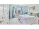Comfortable bedroom with soft blue walls, a plush bed, and a window with a view of a house at 102 Stagville Ct, Cary, NC 27519