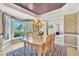 Elegant dining room with hardwood floors, chandelier, custom cabinetry and large window at 102 Stagville Ct, Cary, NC 27519
