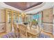 Elegant dining room with hardwood floors, chandelier, custom cabinetry and large bay window at 102 Stagville Ct, Cary, NC 27519