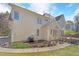 Side view of the home, displaying an outdoor patio and beautifully landscaped garden area at 102 Stagville Ct, Cary, NC 27519