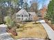 Aerial view of a stately home with manicured lawn, driveway, and mature landscaping at 102 Stagville Ct, Cary, NC 27519