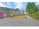 Charming two-story brick home with green shutters, mature trees, and circular driveway at 102 Stagville Ct, Cary, NC 27519