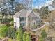Well-kept brick home with green shutters, showing the side of the house and a deck at 102 Stagville Ct, Cary, NC 27519