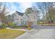 Charming home with green shutters, lush landscaping, and a long driveway leading to a two-car garage at 102 Stagville Ct, Cary, NC 27519