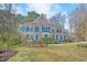 Beautiful two-story brick home with manicured lawn, lush landscaping, and a curved driveway at 102 Stagville Ct, Cary, NC 27519