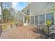 Back of home featuring a spacious deck, large windows, and a well-maintained lawn at 102 Stagville Ct, Cary, NC 27519