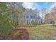 Beautiful two-story brick home with green shutters, mature landscaping, and well-manicured lawn at 102 Stagville Ct, Cary, NC 27519