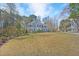 Two-story brick home with green shutters, lush landscaping, mature trees, and well-manicured lawn at 102 Stagville Ct, Cary, NC 27519