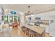 Spacious kitchen features large island with seating, granite countertops, and white cabinetry at 102 Stagville Ct, Cary, NC 27519