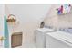 Efficient laundry room with washer, dryer, shelves, and a basket for storage at 102 Stagville Ct, Cary, NC 27519