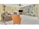 Spacious living area features large windows and cozy fireplace with marble surround at 102 Stagville Ct, Cary, NC 27519