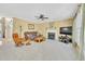 Large living room featuring a ceiling fan, fireplace, and hardwood floors at 102 Stagville Ct, Cary, NC 27519