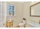 Traditional powder room with decorative furnishings, decorative mirror, and window with natural light at 102 Stagville Ct, Cary, NC 27519