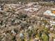 Aerial view showcases a mix of residential areas and shopping centers in an urban landscape at 1051 Wirewood Dr # 202, Raleigh, NC 27605