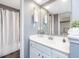 Bright bathroom featuring a white vanity, sleek mirror, and a shower with a stylish curtain at 1051 Wirewood Dr # 202, Raleigh, NC 27605