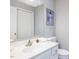Clean, well-lit bathroom with white cabinets, a large mirror, and a toilet at 1051 Wirewood Dr # 202, Raleigh, NC 27605