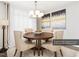 Formal dining room featuring a round wood table, fabric chairs, elegant chandelier, and sophisticated wall art at 1051 Wirewood Dr # 202, Raleigh, NC 27605