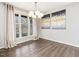 Elegant dining room with hardwood floors, a modern chandelier, and a large window for natural light at 1051 Wirewood Dr # 202, Raleigh, NC 27605