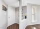 Inviting entryway with a white front door, hardwood floors, and neutral wall color at 1051 Wirewood Dr # 202, Raleigh, NC 27605