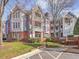 Multi-story condo complex with brick and siding, manicured landscaping, and visible balconies at 1051 Wirewood Dr # 202, Raleigh, NC 27605