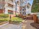 Residential buildings with brick accents, balconies, and landscaped grounds create a welcoming environment at 1051 Wirewood Dr # 202, Raleigh, NC 27605