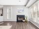 Bright living room with a fireplace, large windows, and beautiful wood floors at 1051 Wirewood Dr # 202, Raleigh, NC 27605