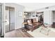 Inviting living room features hardwood floors, neutral paint and a comfortable leather sofa at 1051 Wirewood Dr # 202, Raleigh, NC 27605