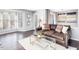 Cozy living room featuring a comfortable leather sofa, natural light from a bay window, and modern decor at 1051 Wirewood Dr # 202, Raleigh, NC 27605
