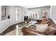 Cozy living room with a fireplace, large windows, and a comfortable leather sofa at 1051 Wirewood Dr # 202, Raleigh, NC 27605