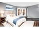 Staged main bedroom featuring neutral walls, a queen bed, and a large window at 1051 Wirewood Dr # 202, Raleigh, NC 27605