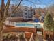 Beautiful condominium complex with a swimming pool and brick patio surrounded by white fencing at 1051 Wirewood Dr # 202, Raleigh, NC 27605