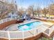 Inviting community pool surrounded by brick walls and white fencing, perfect for relaxation at 1051 Wirewood Dr # 202, Raleigh, NC 27605